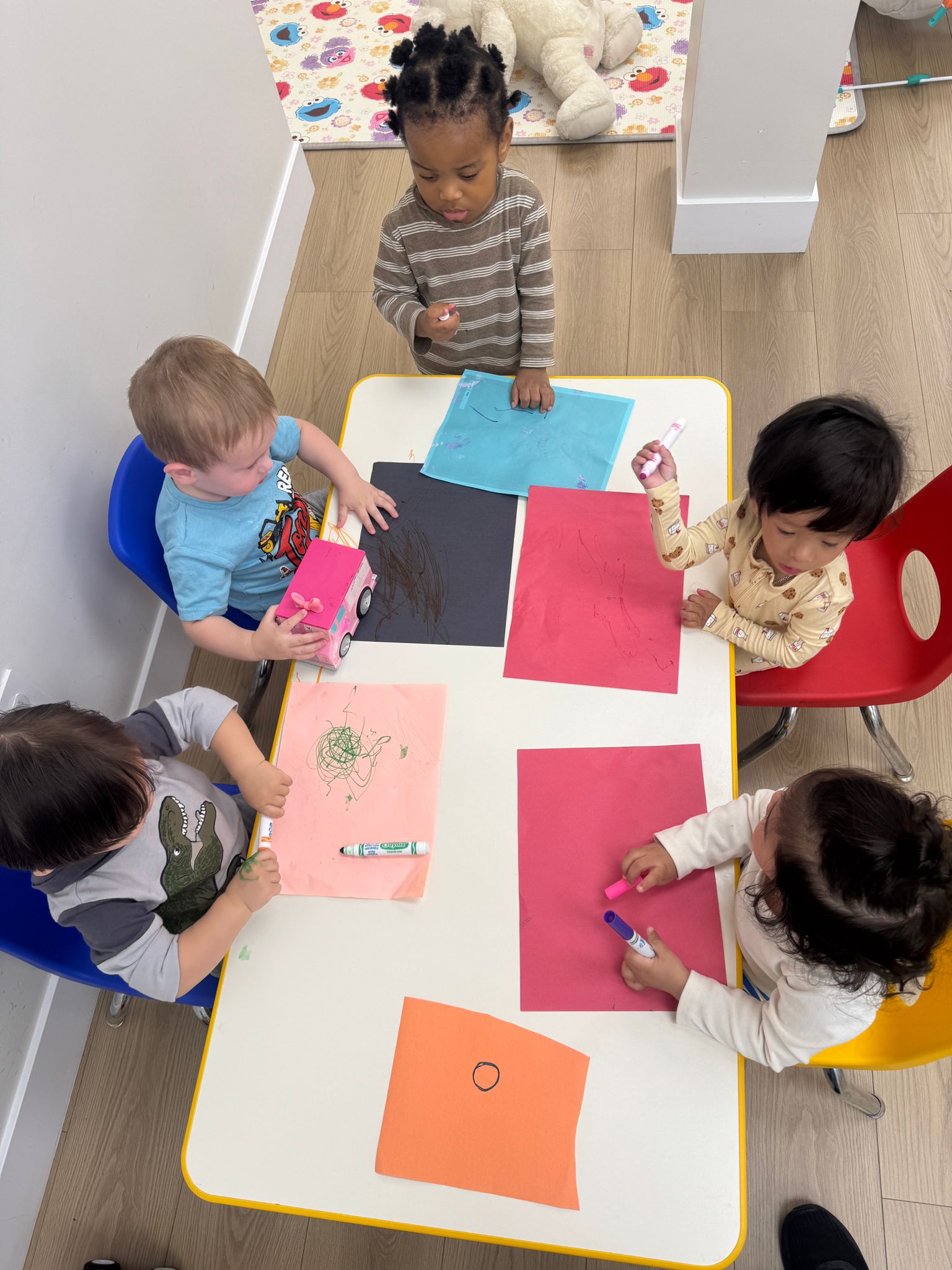 Children drawing together at a table.