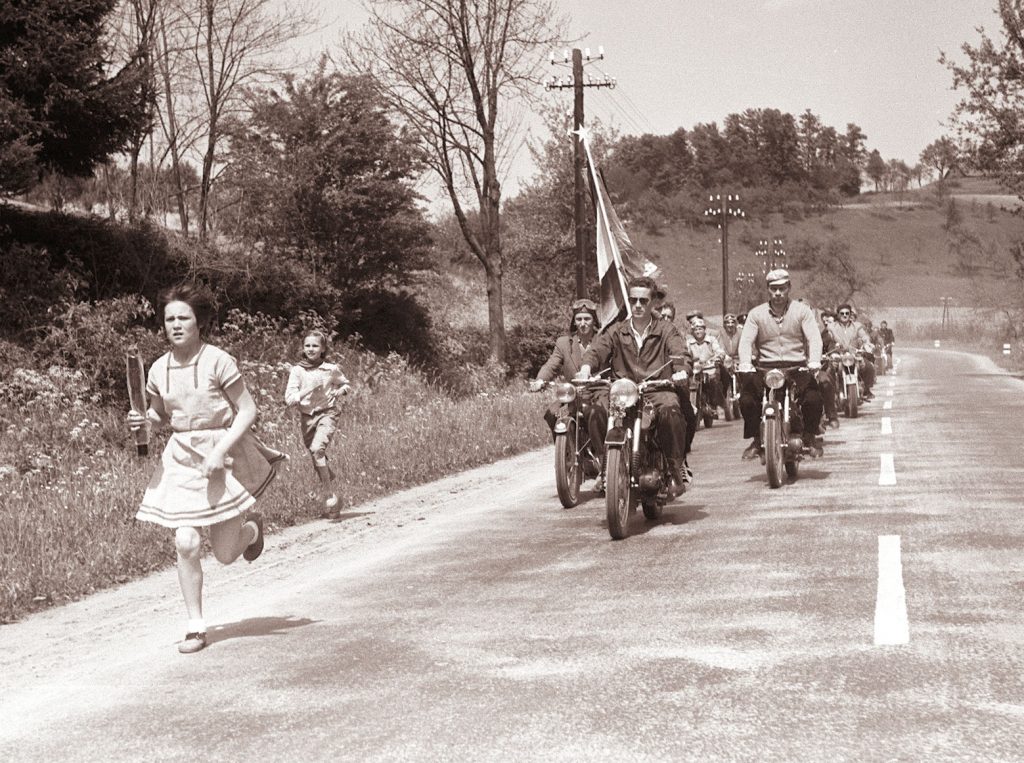 Girl running with relay baton