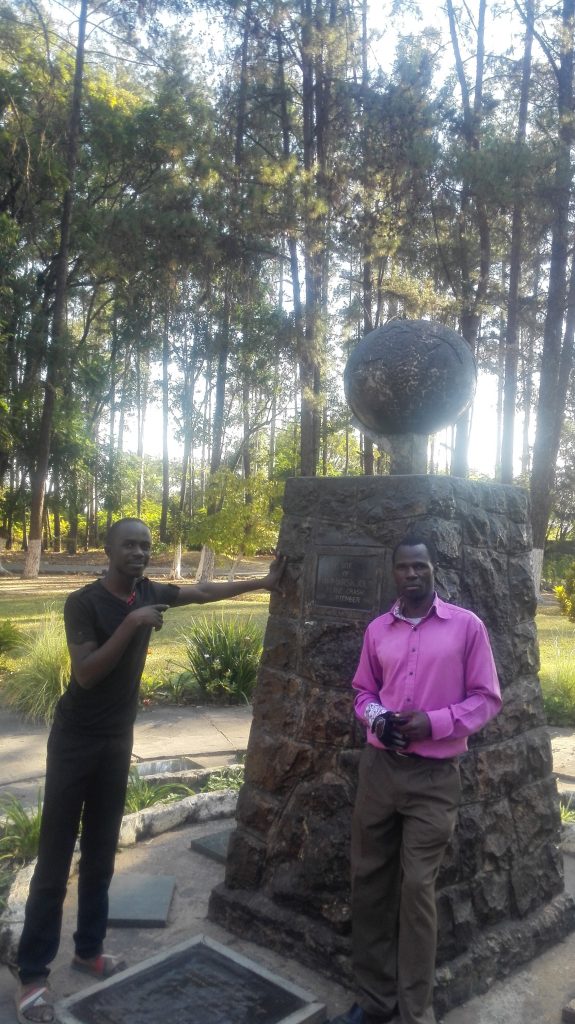 Standing by the monument with the site manager in the picture