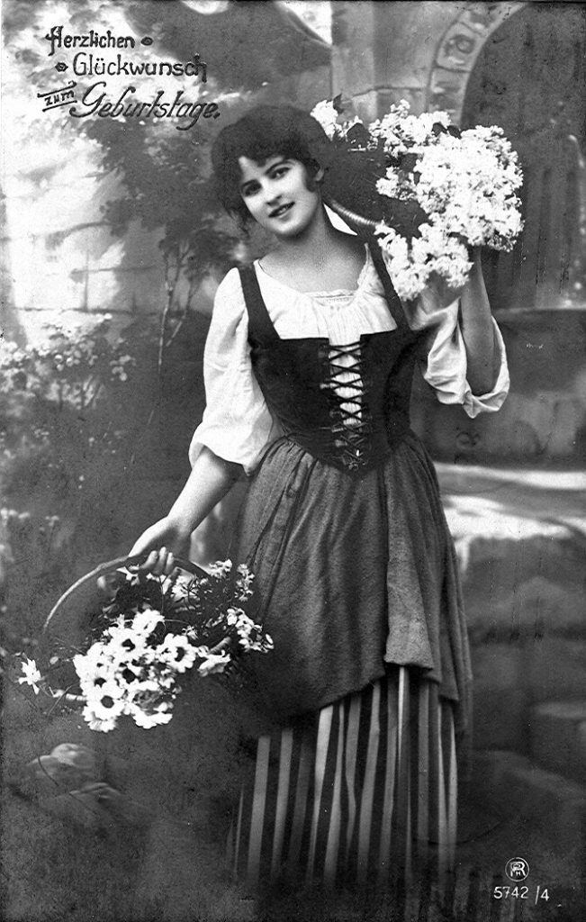 A postcard from 1918 showing a woman in Dirndl. Modern designs tend to have shorter skirts, up to the knee.