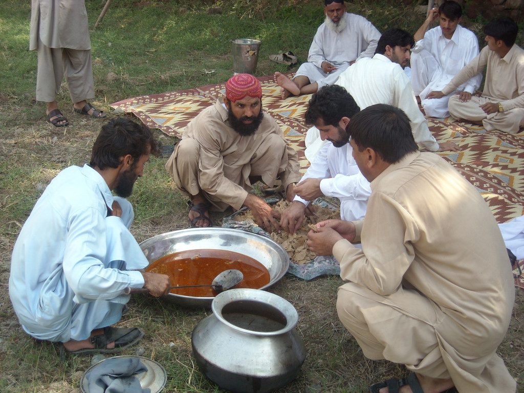 Men enjoying a traditional meal of Sohbat. Photo credit: Drabankalan/Flickr