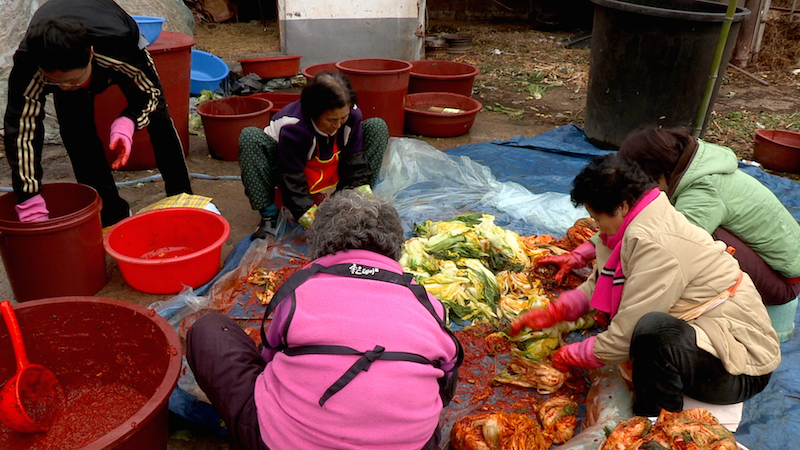 A family is making Kimchi at homeImage Source : Cultural Heritage Administration, Republic of Korea
