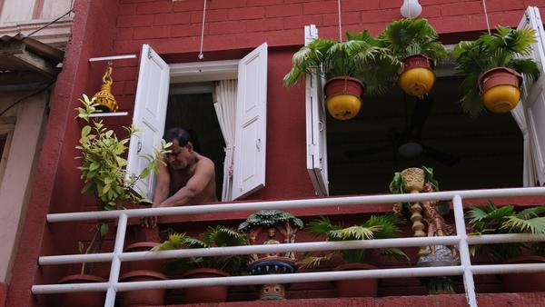 ahmedabad-a-man-peeps-out-of-the-window-in-his-house%0a