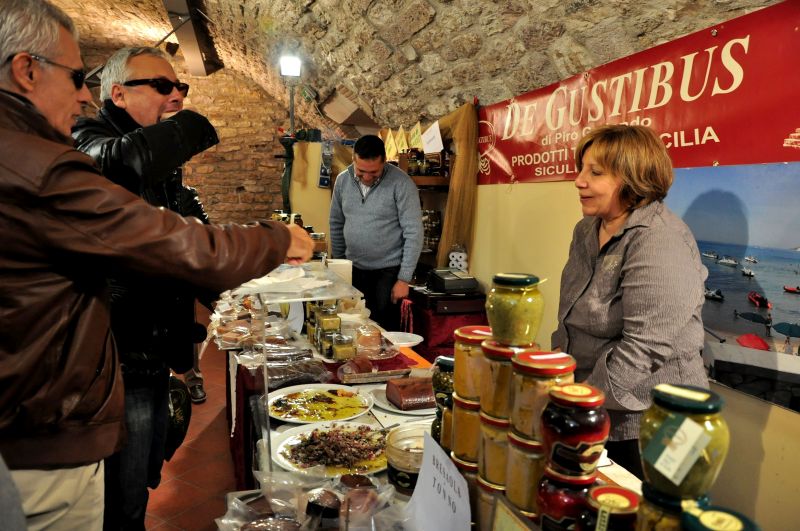Tasting Sicilian specialties at the Gubbio festival. Photo credit: walksofitaly.com
