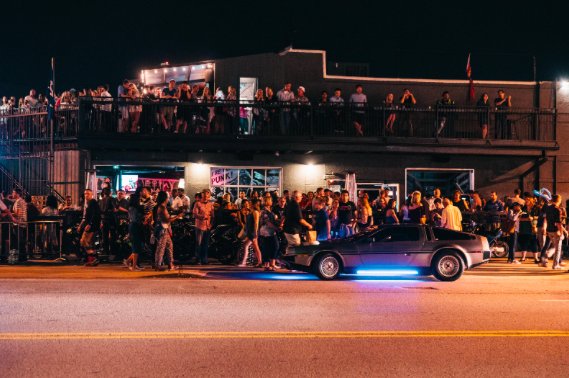 Themed bars and wild cars are lined up throughout the crossroads during First Fridays