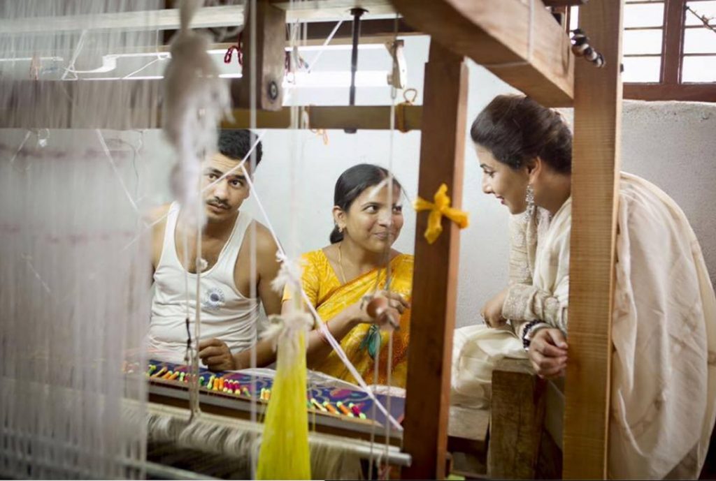 Actor Vidya Balan interacts with workers at the handlooms.