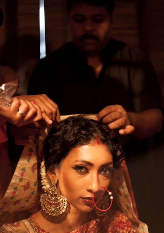 Gaurang preps a model before a fashion show.