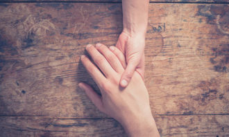 Priya-Oct-2019-cancer-treatment-hands-close-up-123RF