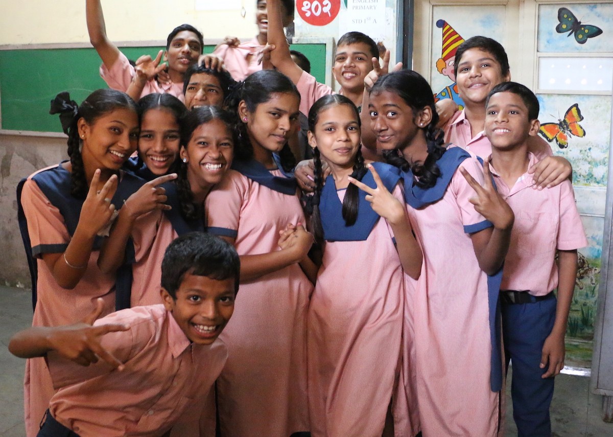 kids gather to take a photo during B1G1's visit to Midday Meals
