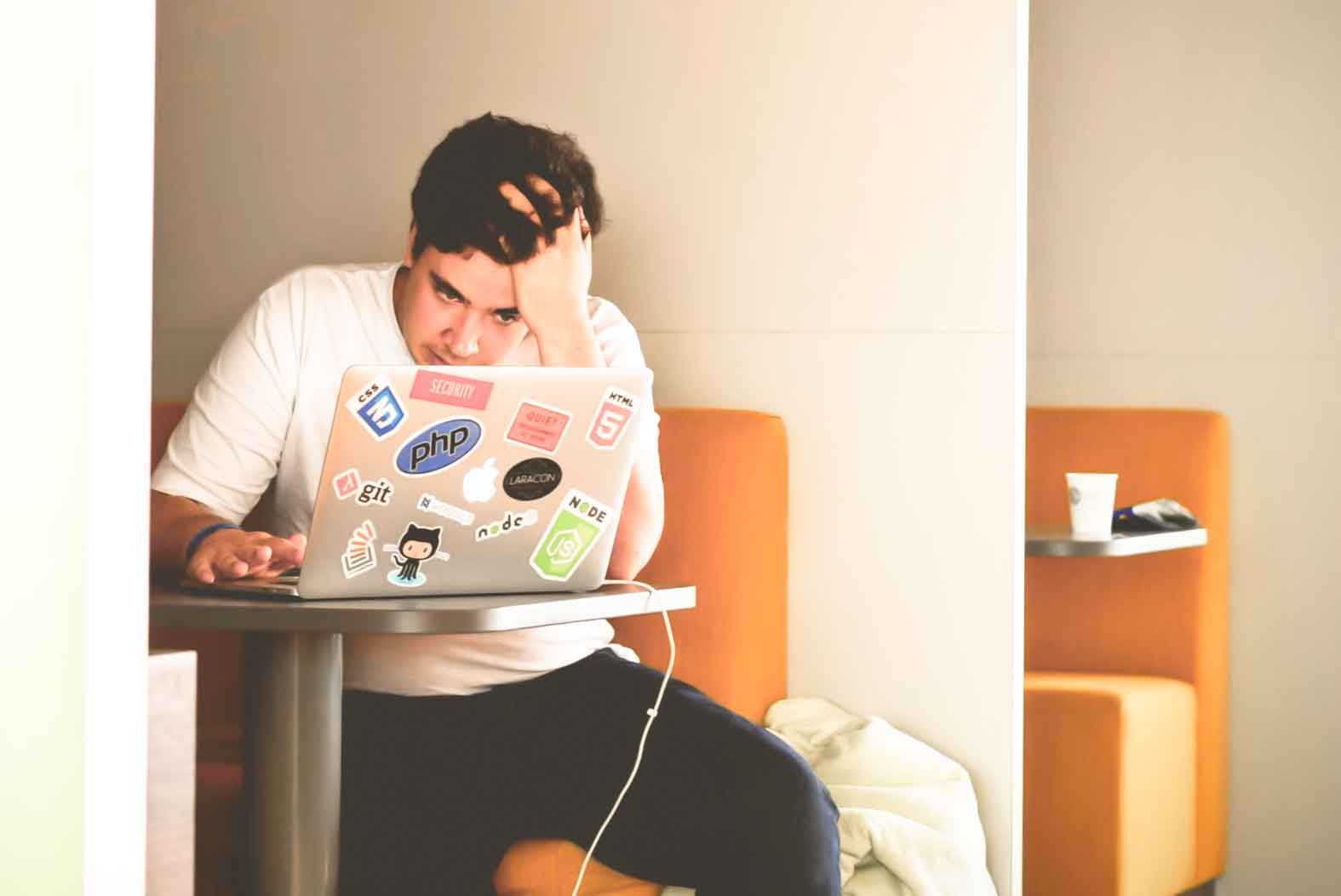 man looking in front of his screen facing college rejection