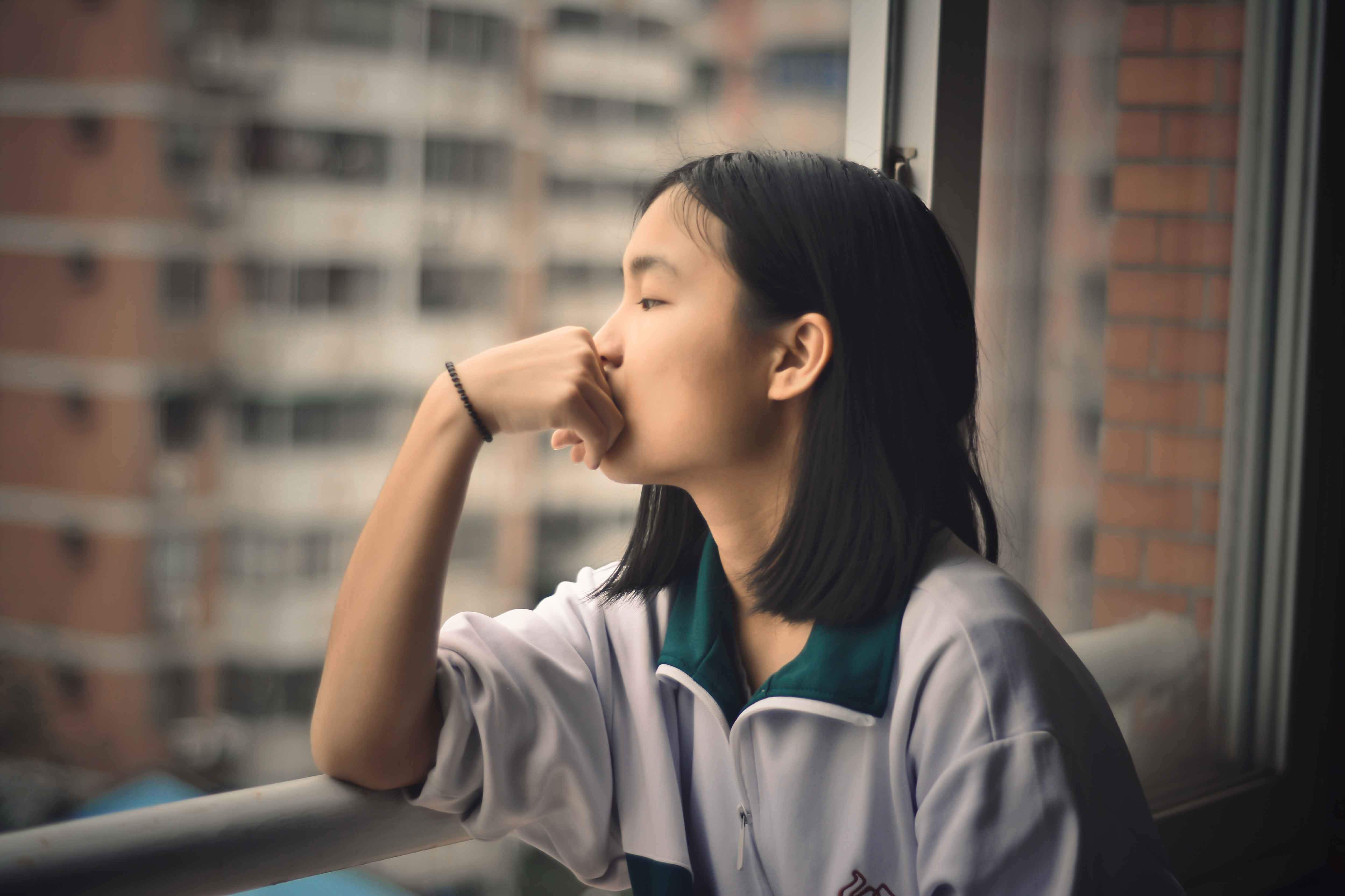 student facing a window