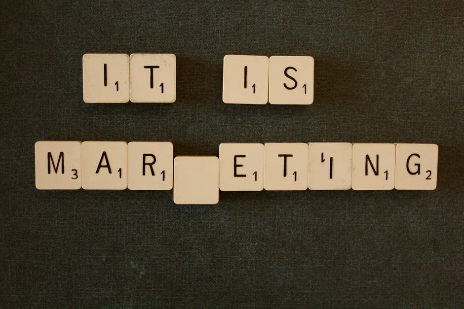 Scrabble pieces spelling out the sentence, "it is marketing."