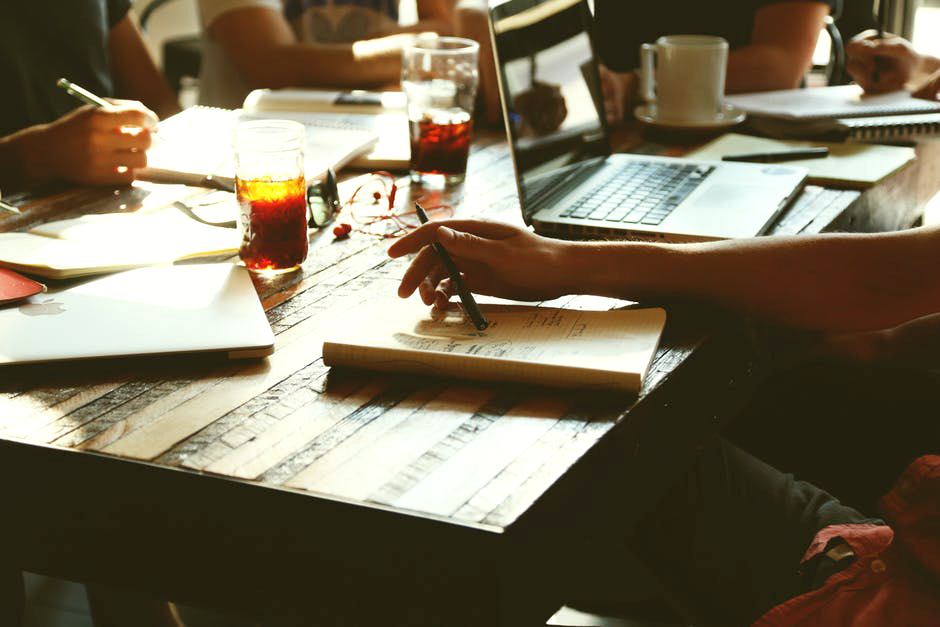 image of a laptop, and person doing notes