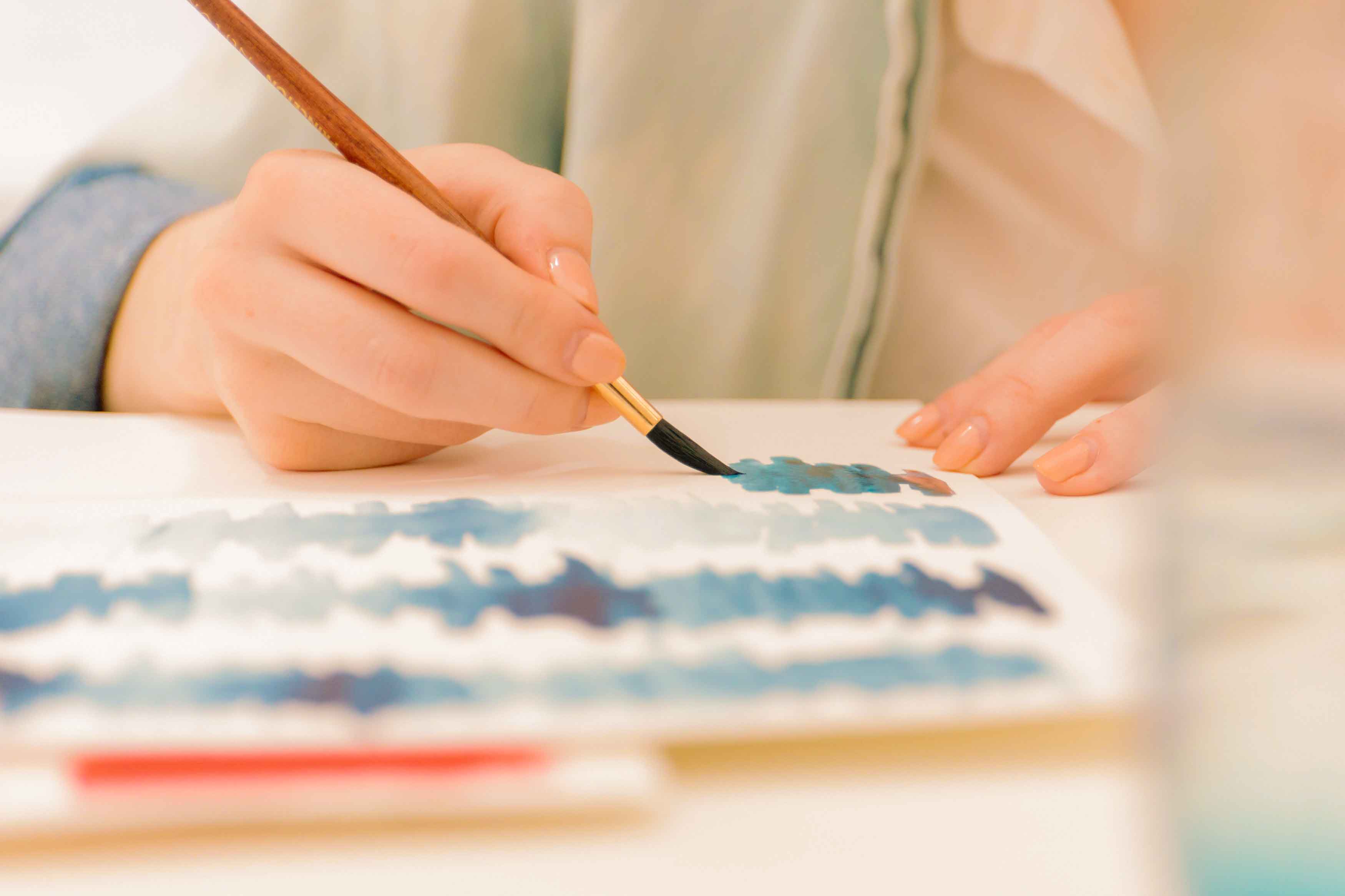 Hand painting watercolor onto paper