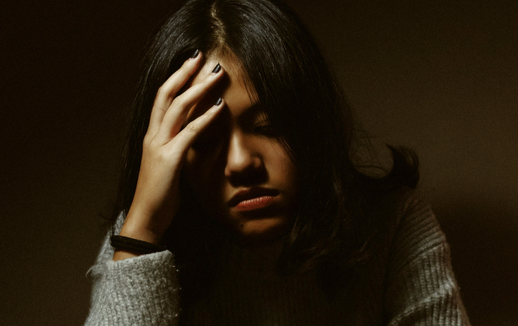 Girl facepalming in sadness