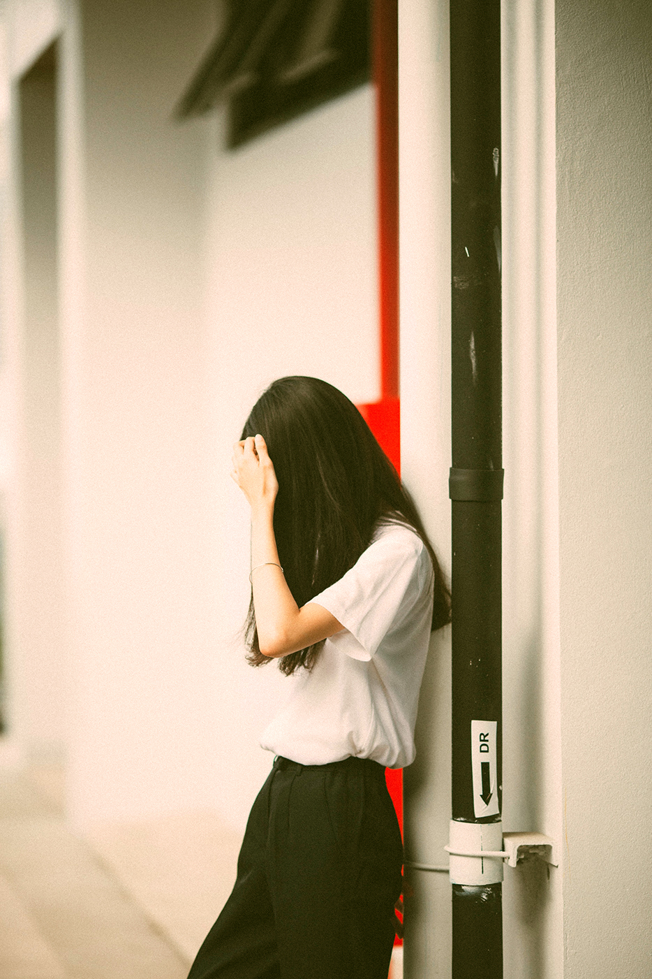 woman standing while holding her head