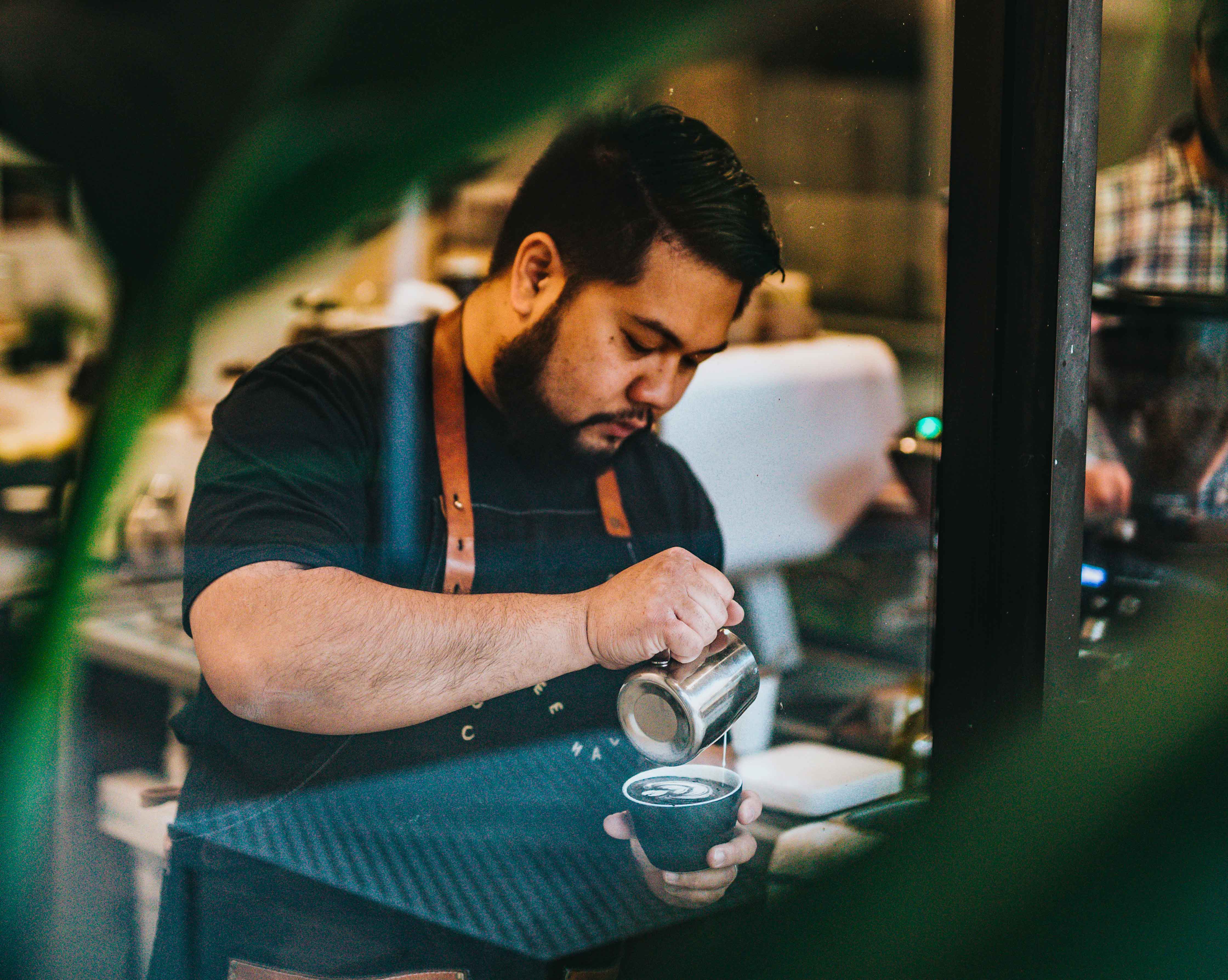 working student pouring coffee on a mug