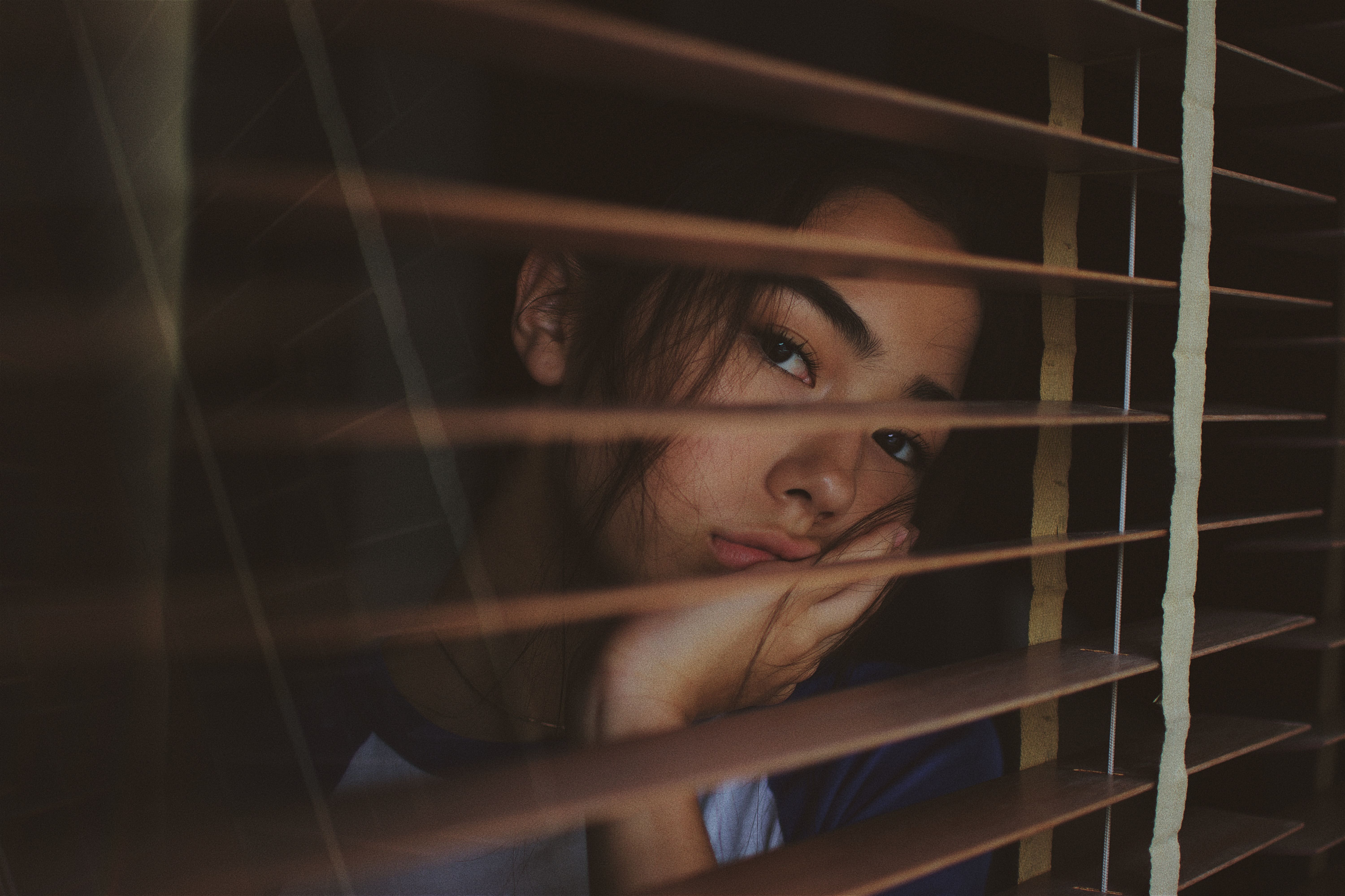 sad woman looking from a window