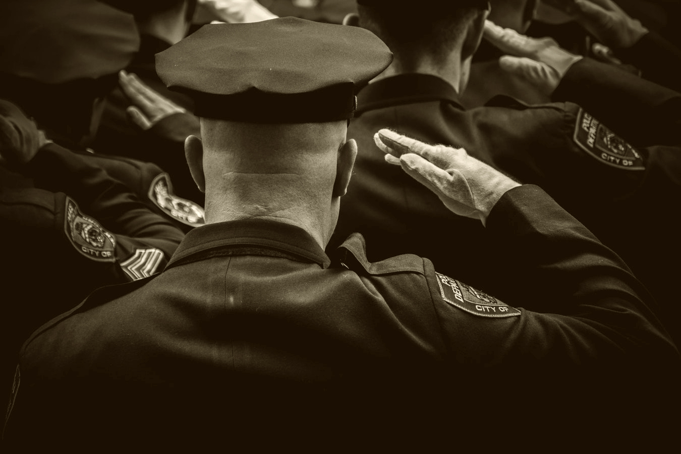 Men in uniform with arms raised in salute