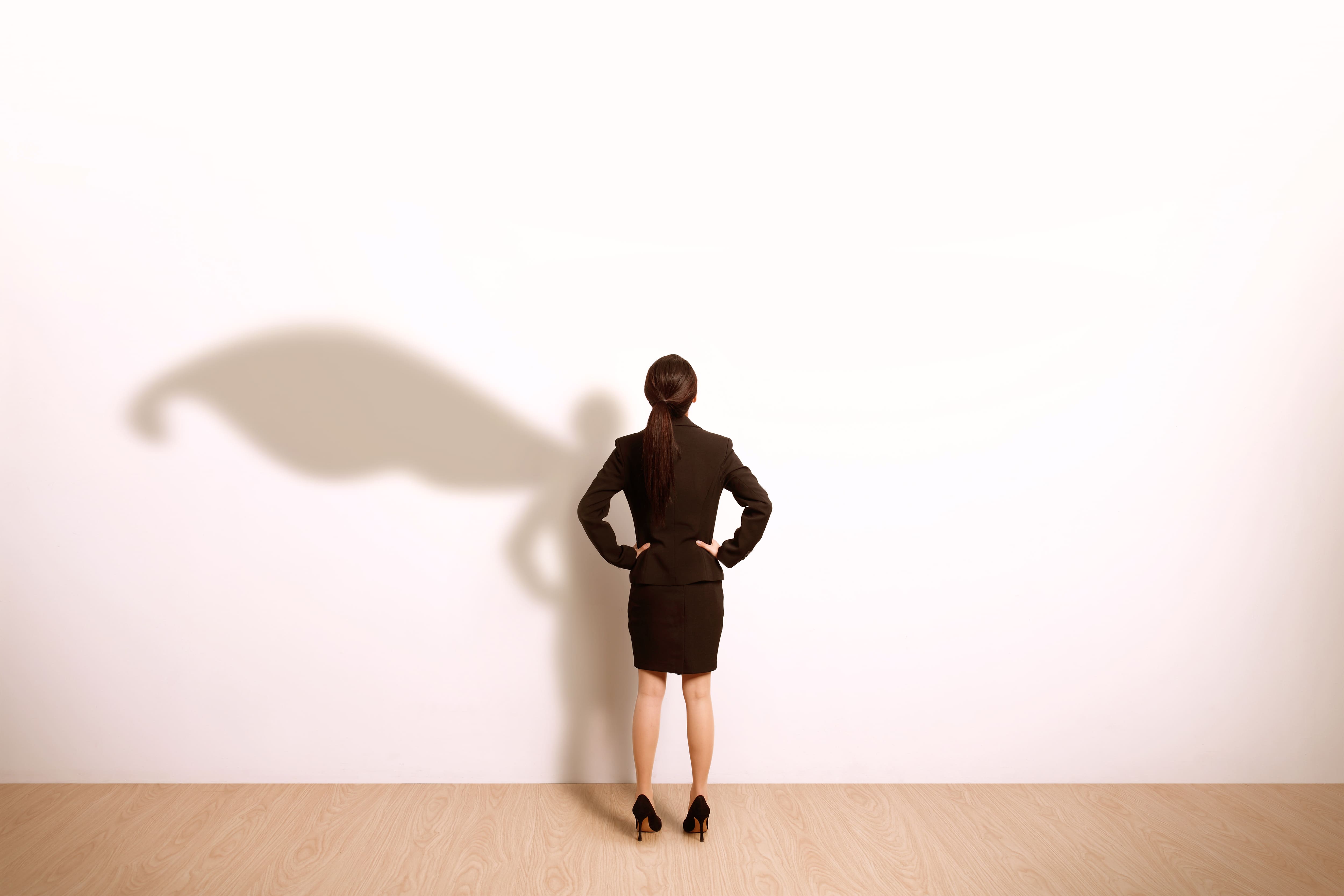 career woman standing strong like a superhero