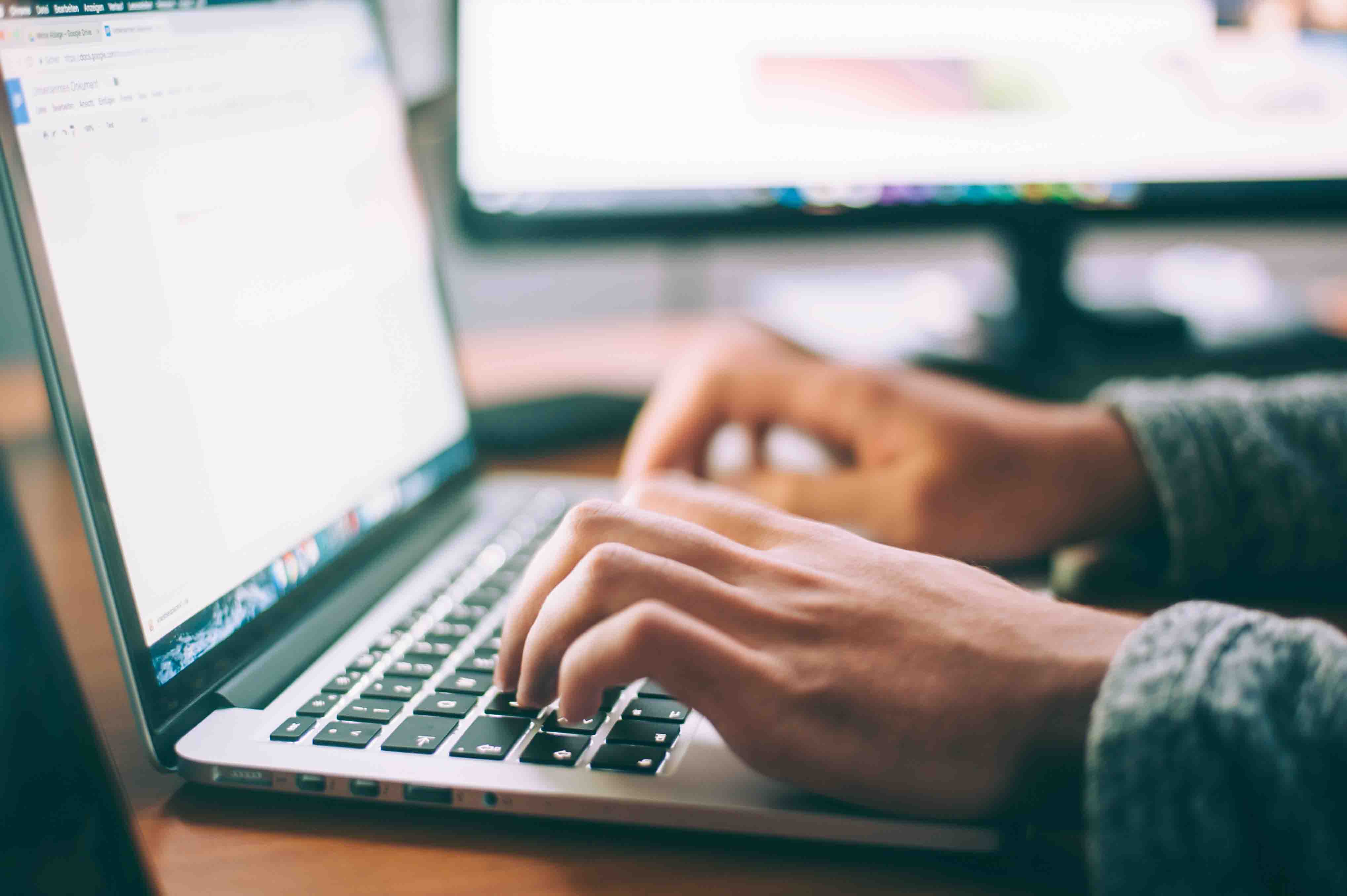 person typing on laptop