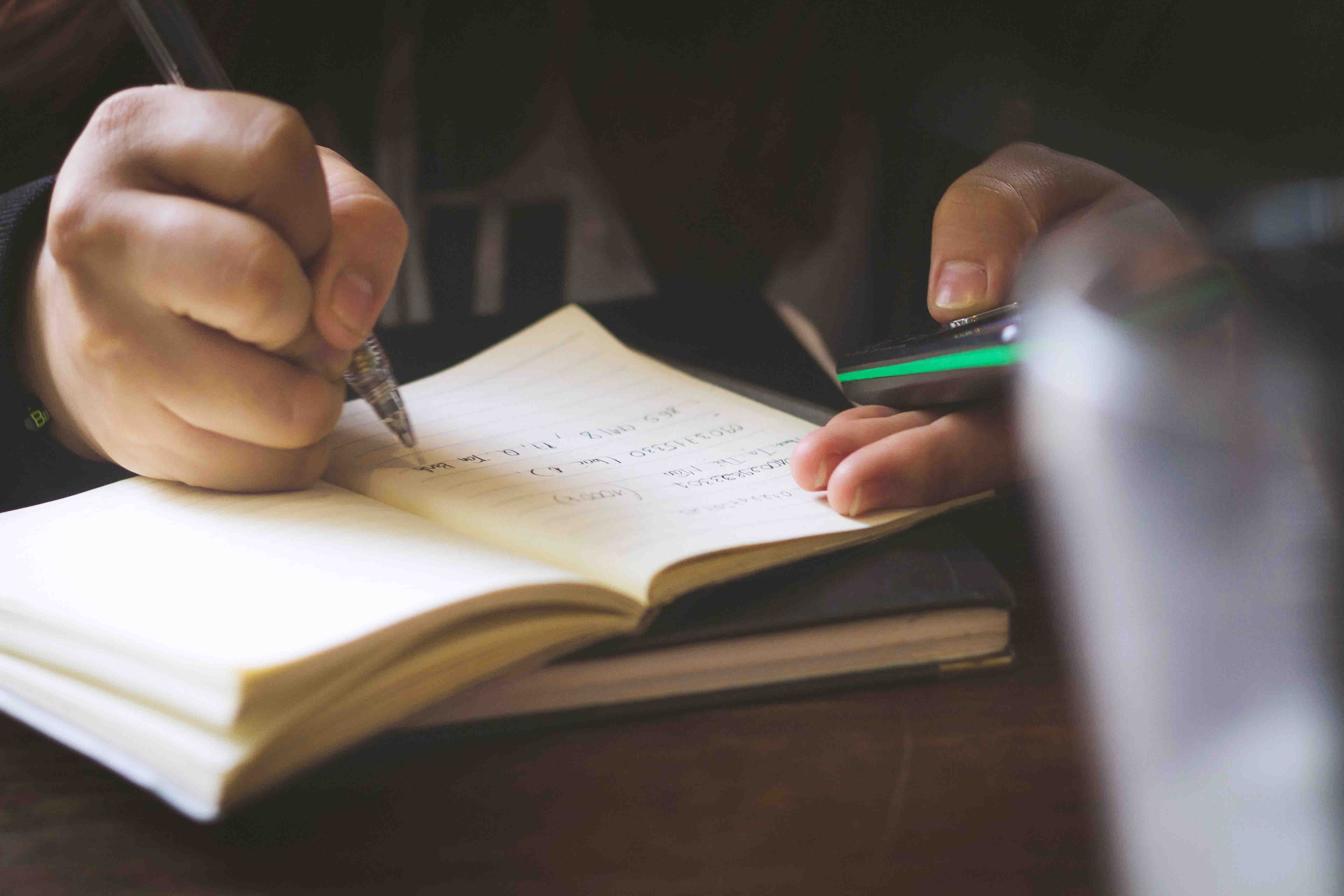 hand writing on a notebook