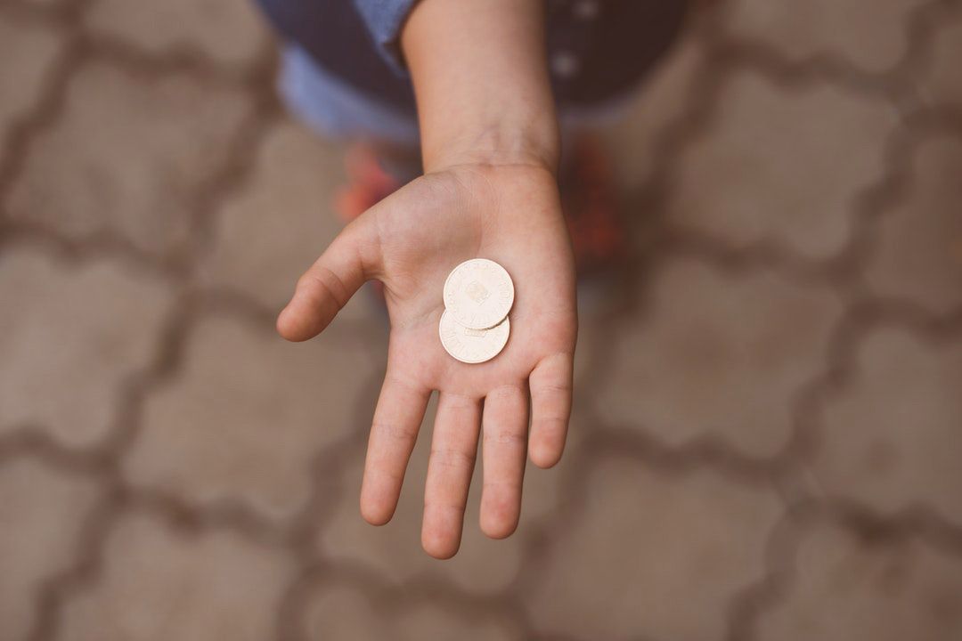 open palm holding two coins