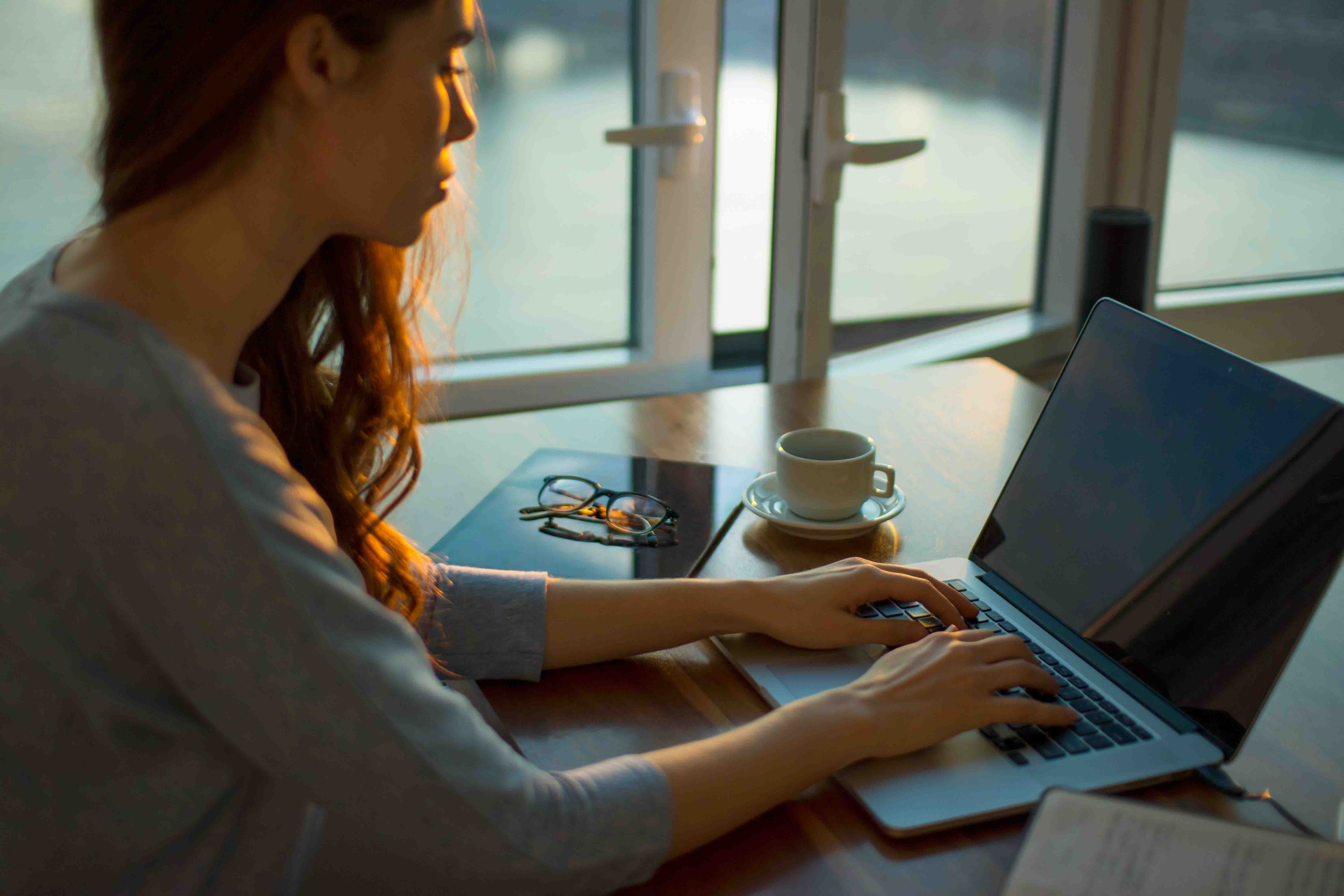 girl typing using laptop