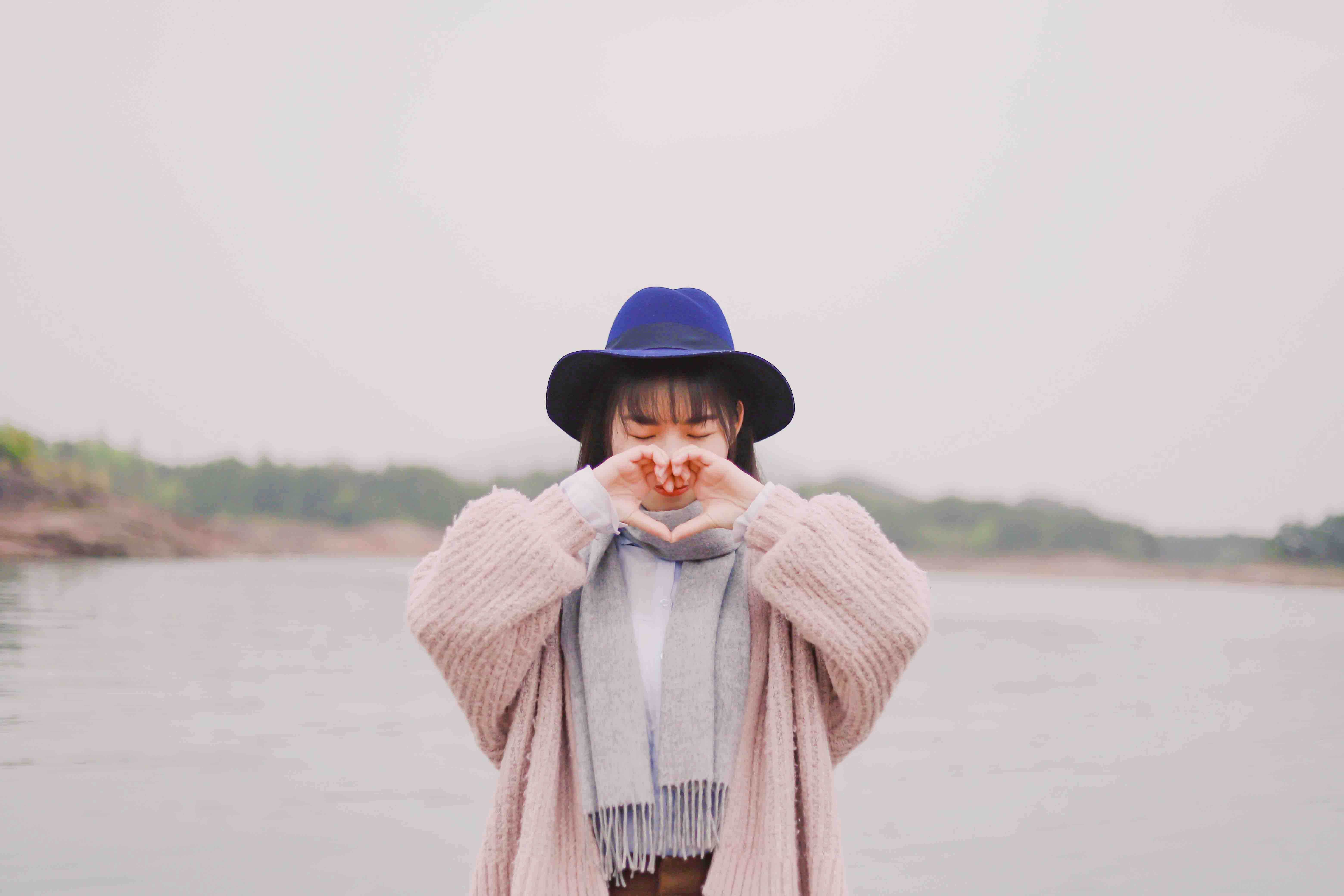 girl doing a heart sign