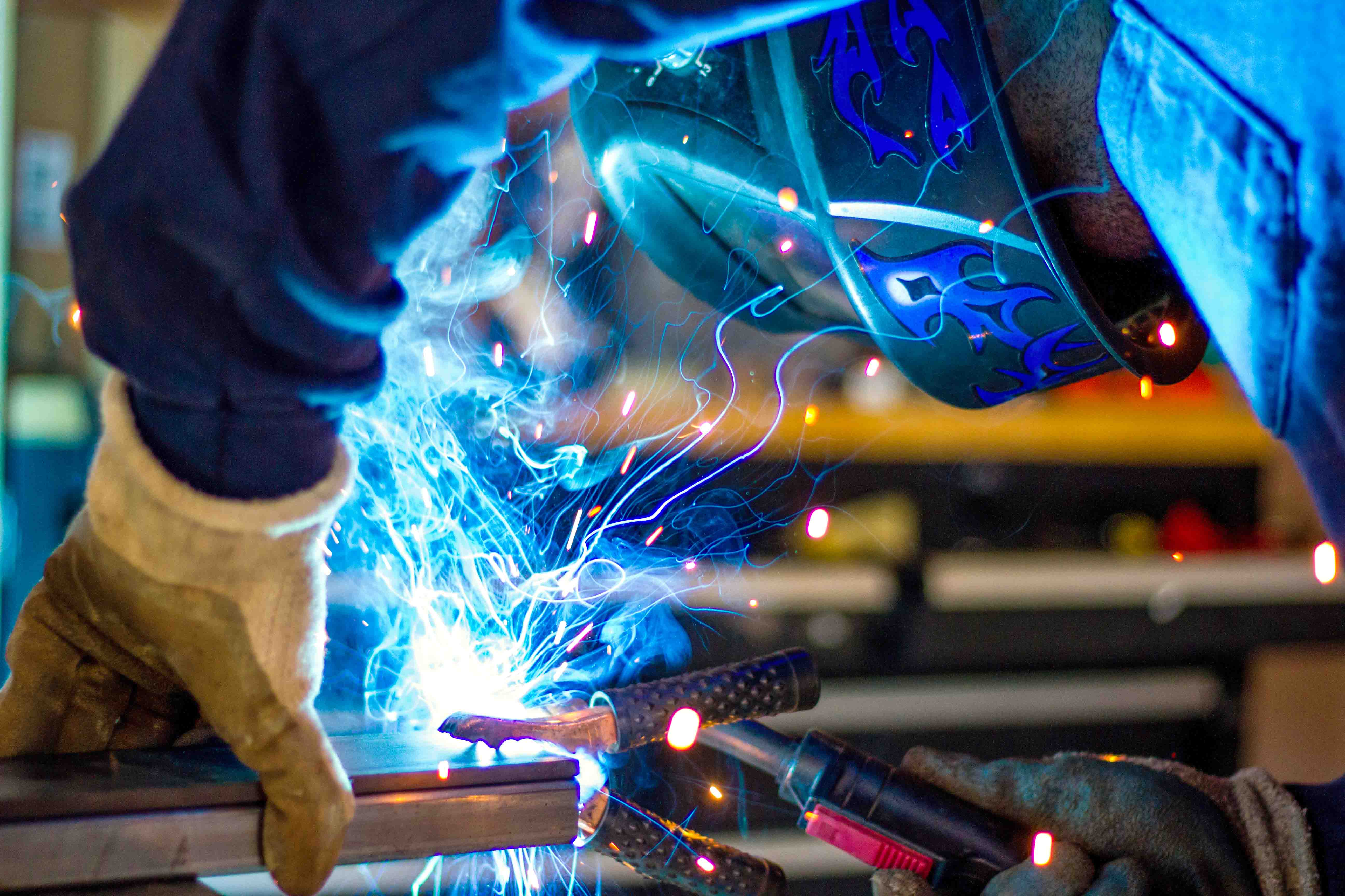 man in a mask welding metal