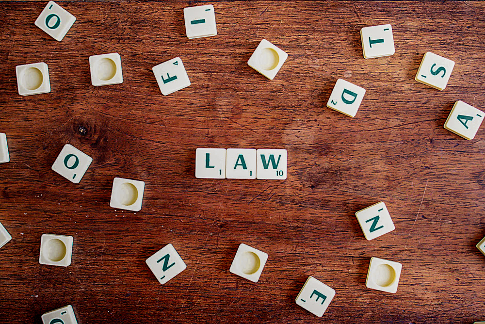 scrabble letters spelling l-a-w