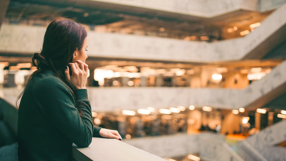 Girl looking out from a balcony