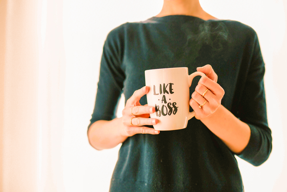 woman holding a mug with text design "like a boss"