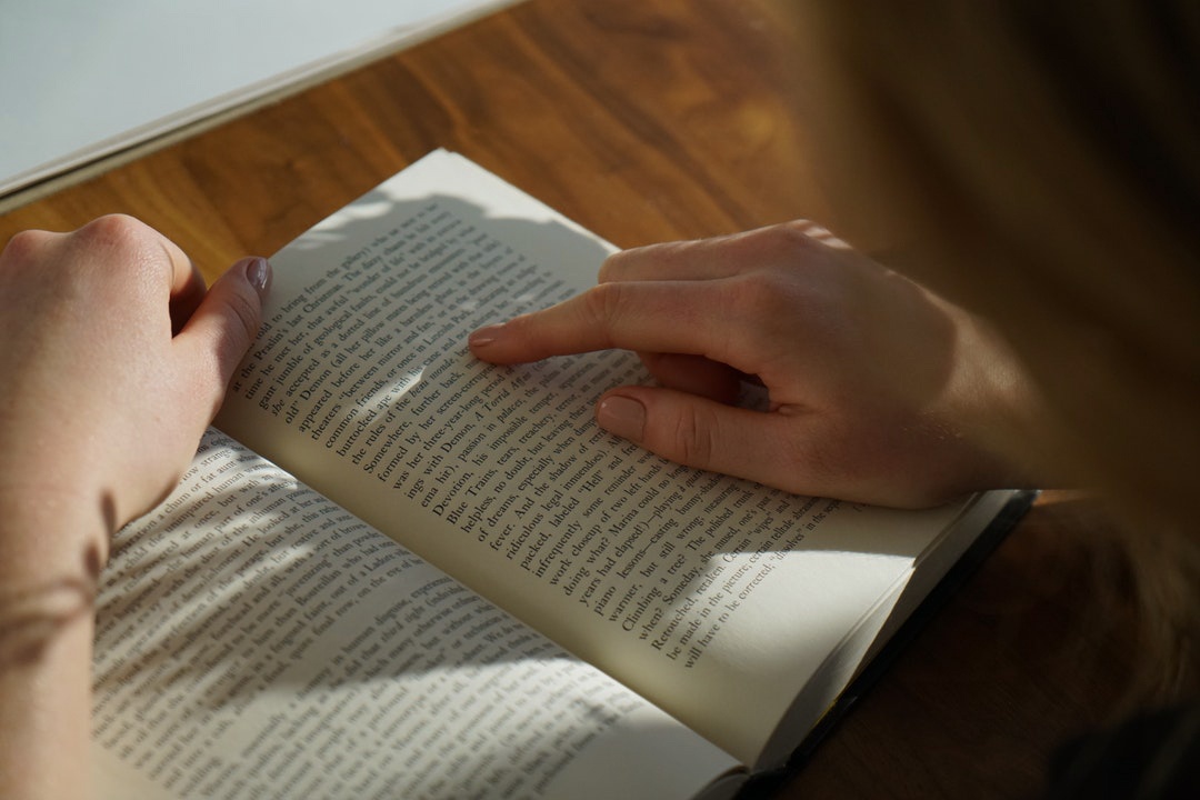 hand of a person skimming through a book