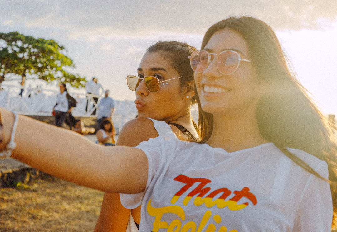 two girls taking a selfie at the beach
