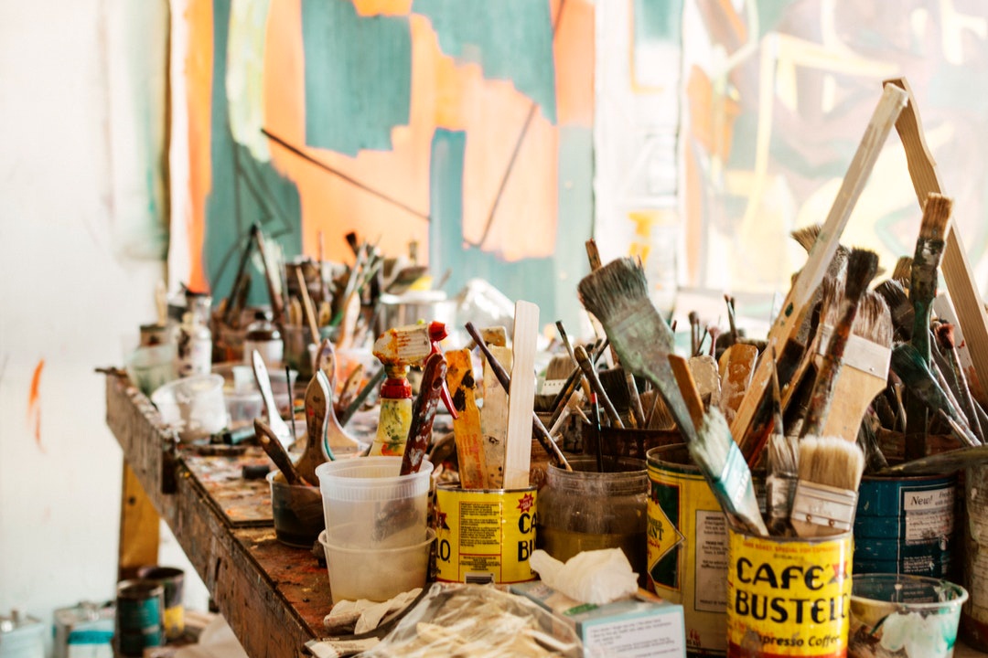 table full of paint brushes