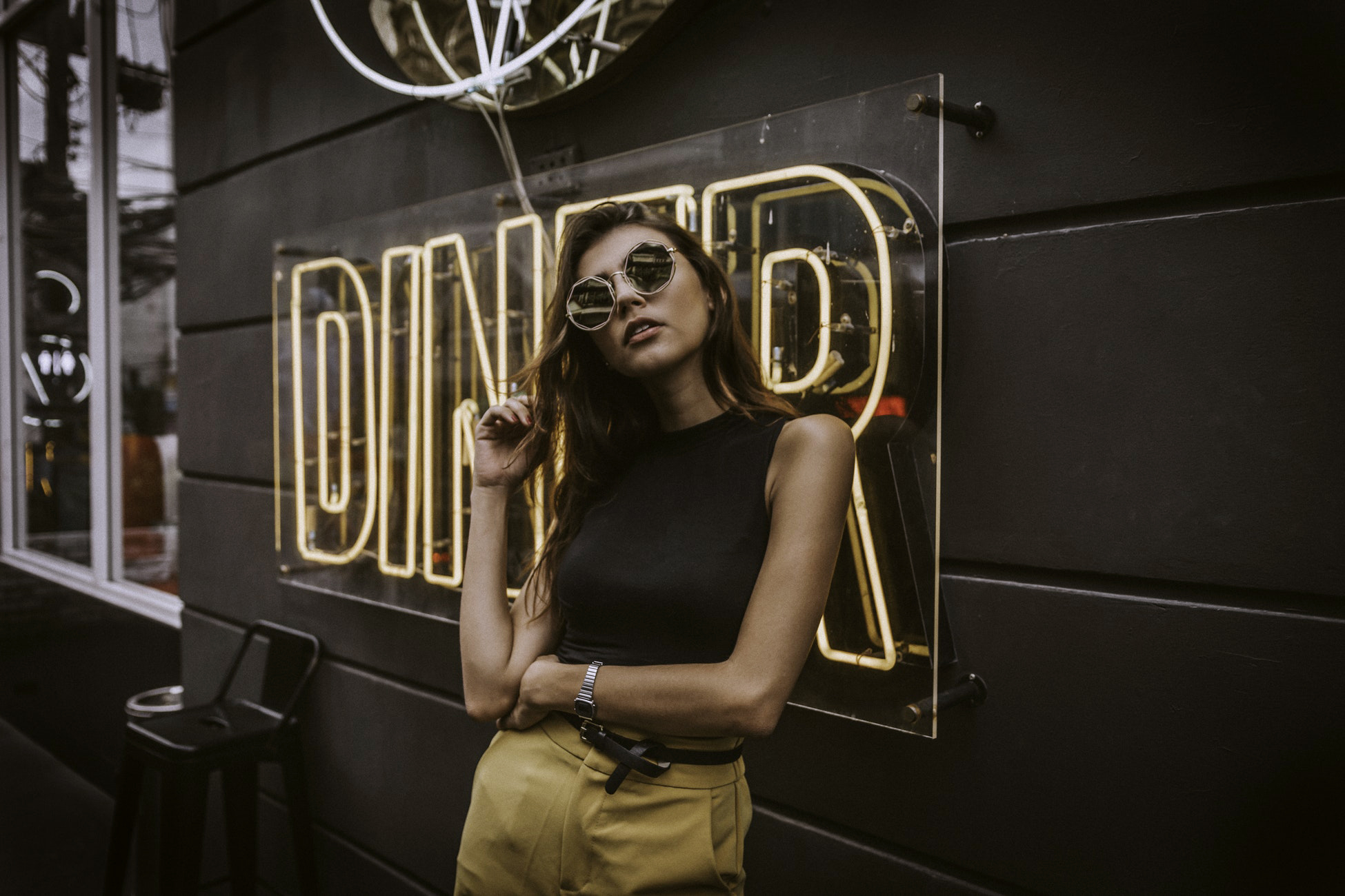 woman standing in front of a signage with words diner