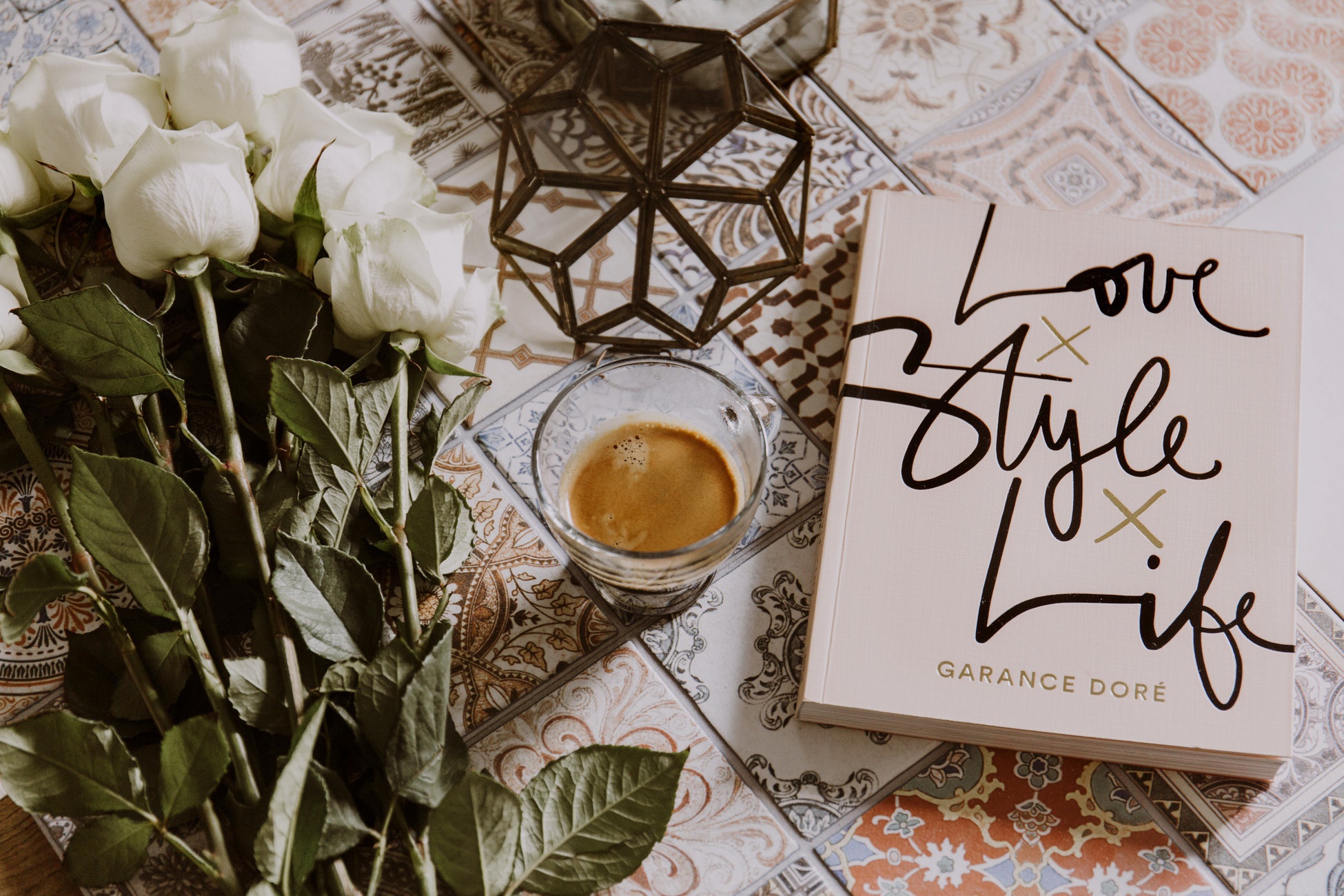 flatlay of books, plants, and coffee