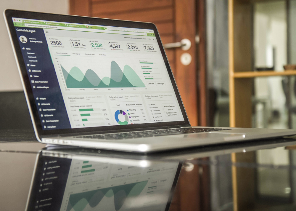 open laptop showing graphs and numbers