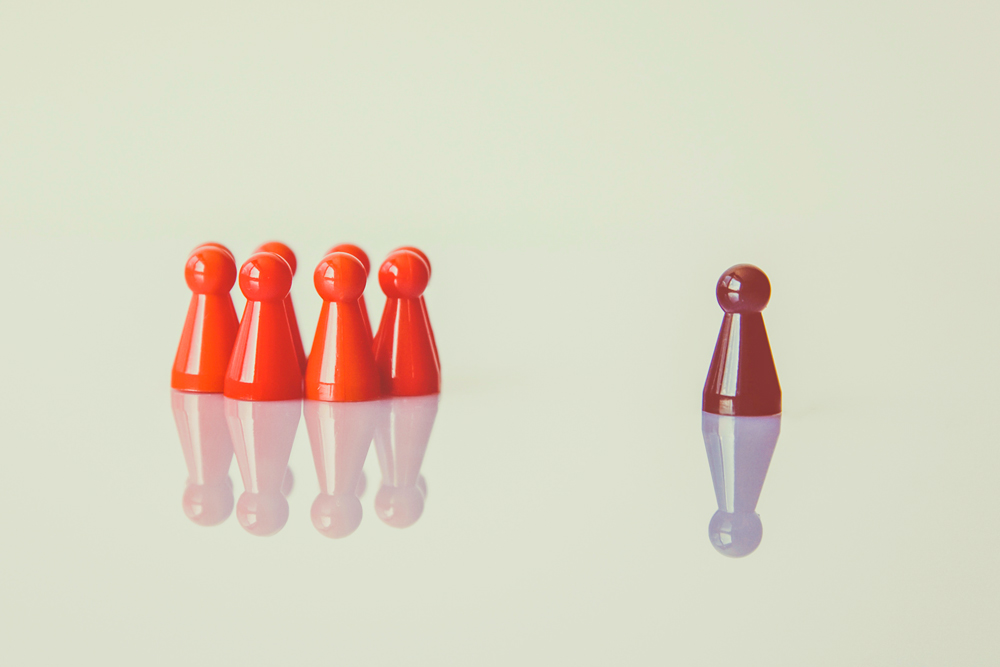 five chess pawns where one stand out