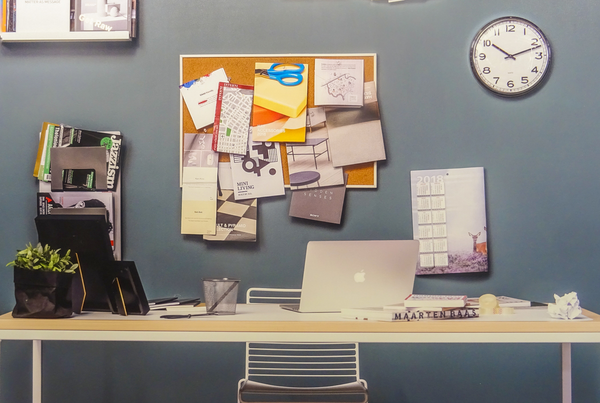 desk with a laptop and sticky notes