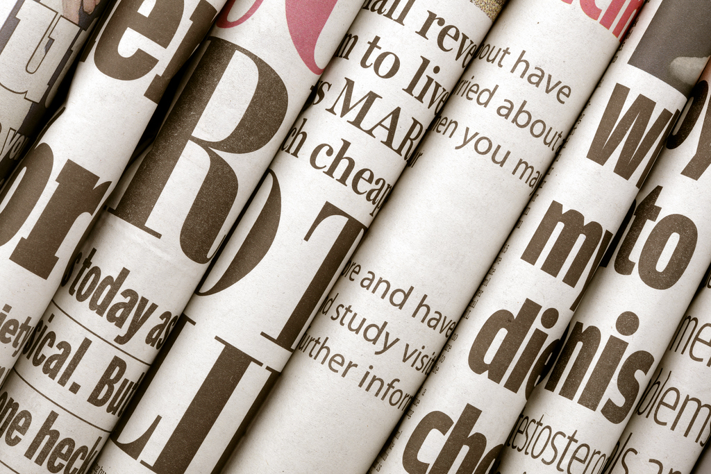 rolls of newspaper headlines