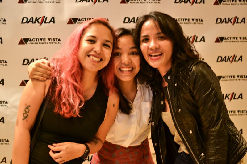 Kelsey Hadjirul smiling with her two moms, Cha Roque and Ymi Castel