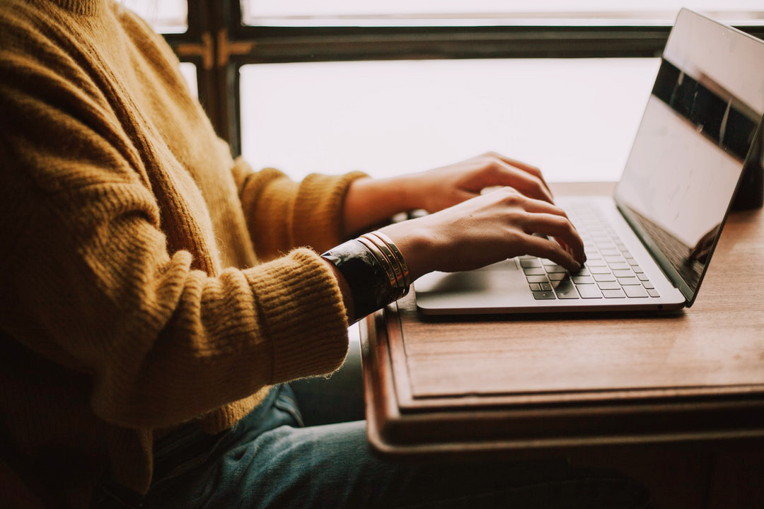 woman typing on laptop