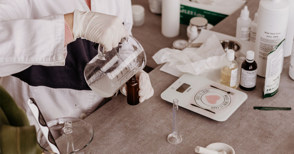 woman in gloves and lab coat handling medical equipment