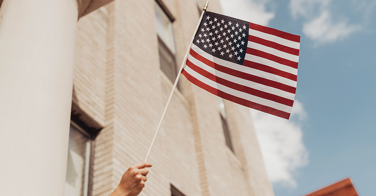 hand waving the USA flag
