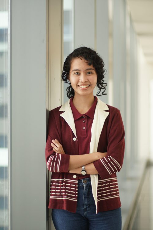FTW scholar Larisse Almirañez smiling beside a window