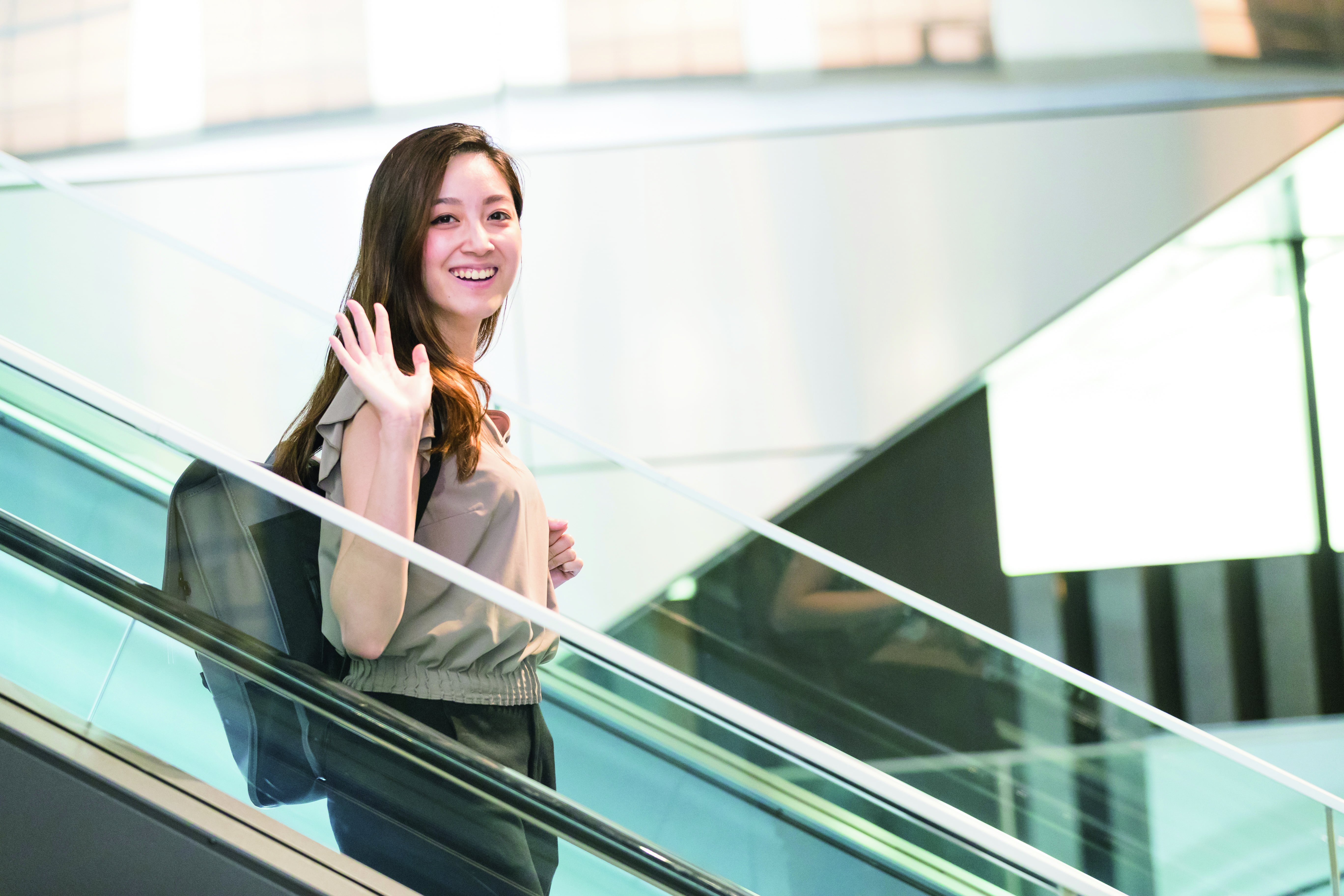waving female student studying at japanese university waseda