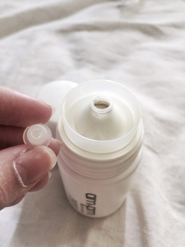 Remove this plastic piece to allow powder to be dispensed.