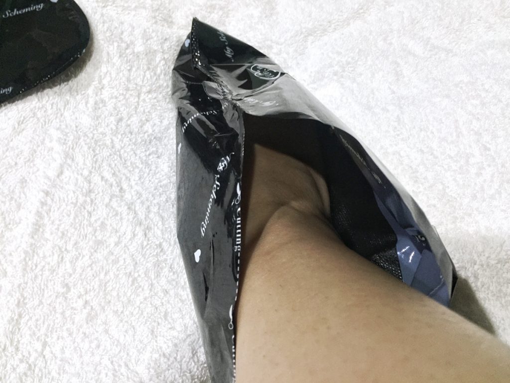 3. Once open, carefully slip the mask on each foot.